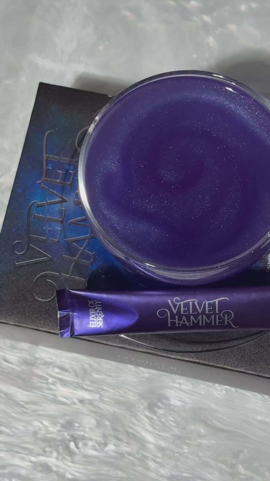 Elixir of Serenity in a glass on top of a book