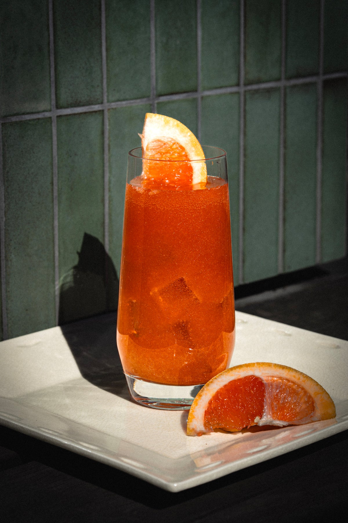 Orange cocktail on a green tile