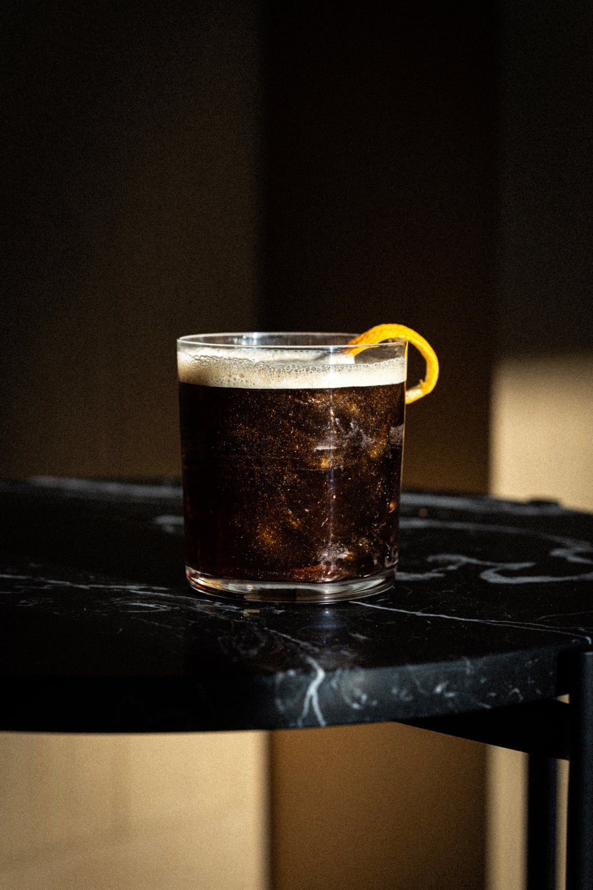 Dark cocktail with an orange twist