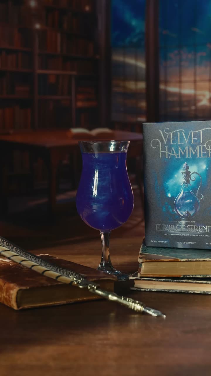 A glass of violet Elixir of Serenity on a wooden table in a library